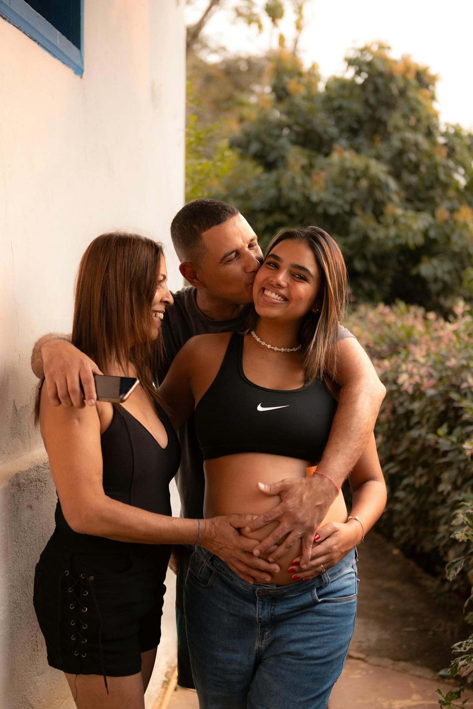 A family together indoors and smiling for a portrait